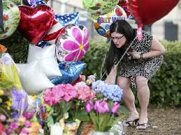 A woman lay wreath to mourn the deceased journalists