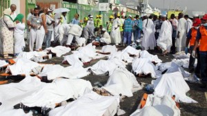 *Dead victims of the hajj stampede with emergency officials and others on Thursday.