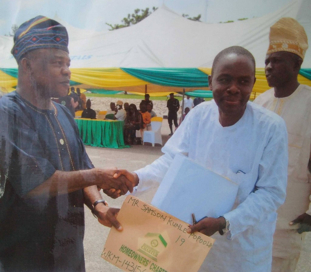 Architect Samson Kunle Popoola…Receiving his documents from Adeoluwa.