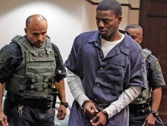 Okafor…in handcuffs during the trial.