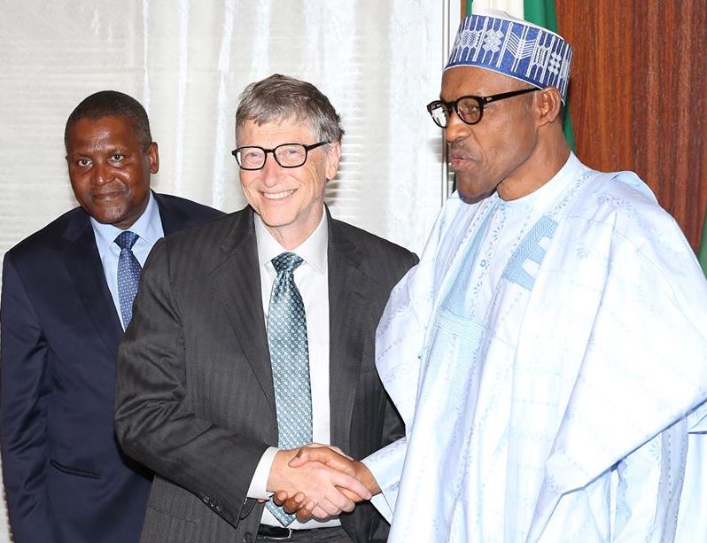 Buhari in handshake with Bill Gates, while Dangote watches during the visit.