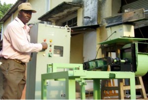 *Prof. Adewumi on a demonstration machine at the developing stage of the classifier rig.