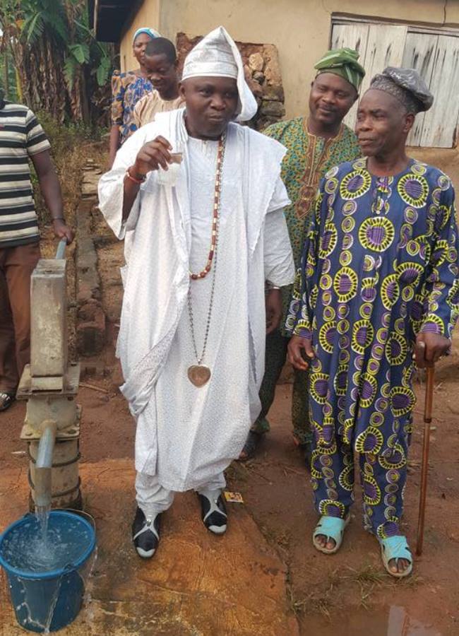 Fadare drinking the water to the admiration of his people.