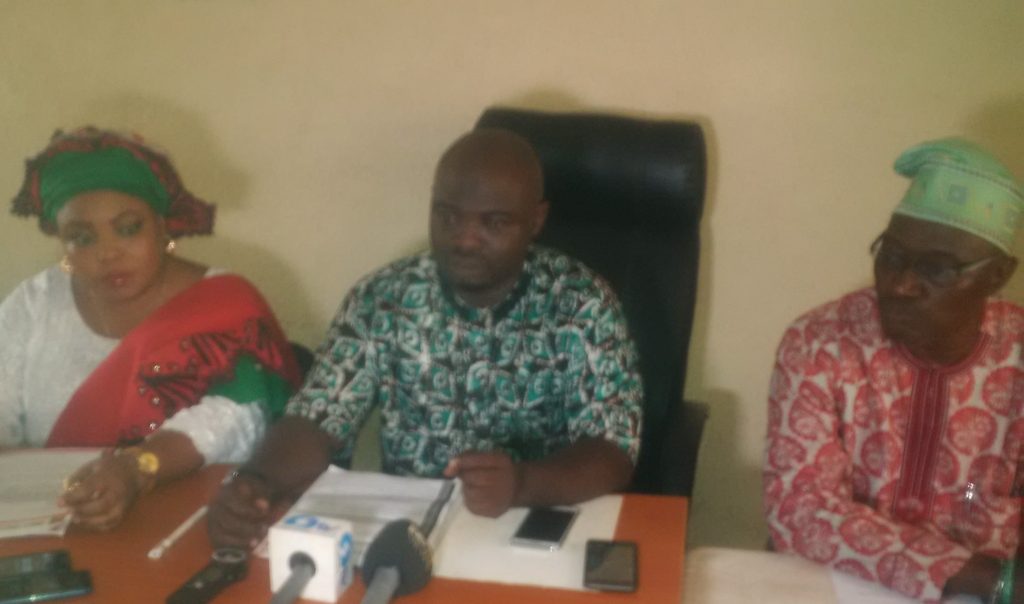 From left are Olatubosun, Popoola, and Folarin at the press conference announcing the suspension.