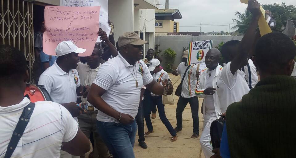 Peace corps officials in joyous mood.