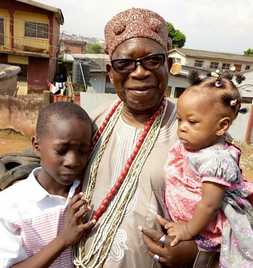 Oba Ogunleye with his grandchildren on his way back to school on Sunday.