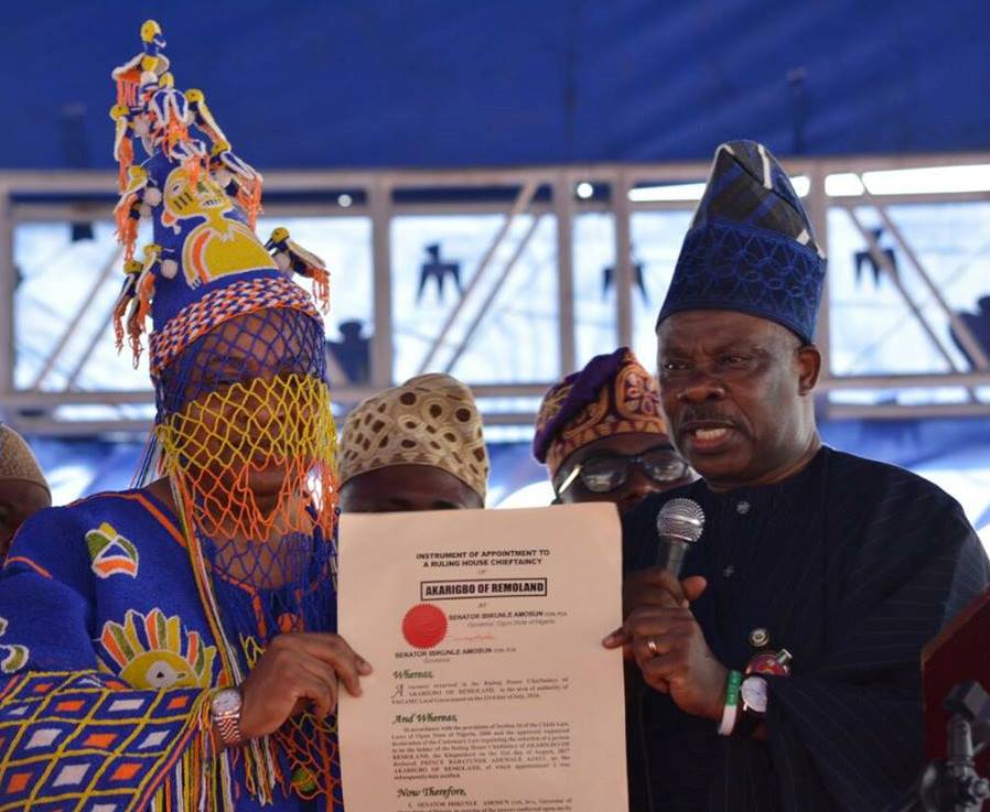 Oba Ajayi collecting his certificate from Amosun at the ceremony.